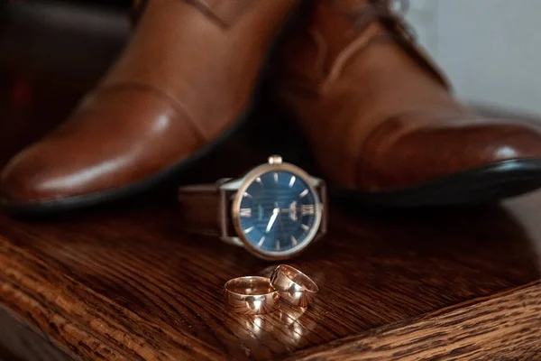 Wedding accessories, shoes, watches, rings, bow tie. The concept of marriage, family relationships, wedding paraphernalia.