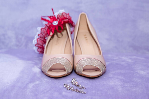 composition - wedding shoes with decor and accessories. The concept of marriage, family relationships, wedding paraphernalia.