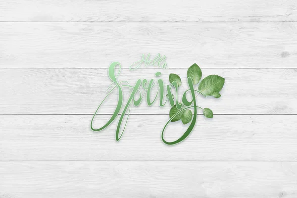 Handwritten inscription hello spring. Spring floral natural background. Copy space.