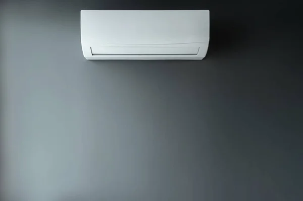 White air conditioning on a gray wall background. The concept of heat, cool air, cooling, freshness.