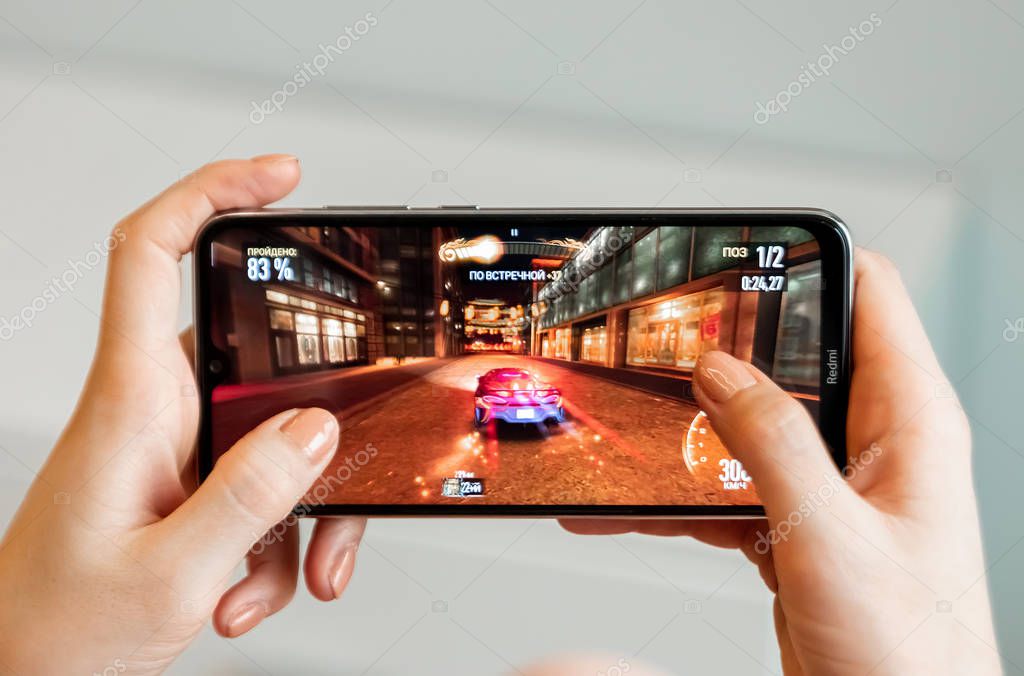 Brest, Belarus, January 31, 2020: Mobile game Need For Speed no Limits on a close-up of the screen of the Xiaomi Redmi Note 8 smartphone. A person plays a game on a smartphone