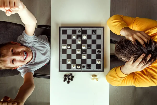 Boy Rejoices Chess Victory His Father Play Chess Family Relationships — Stock Photo, Image