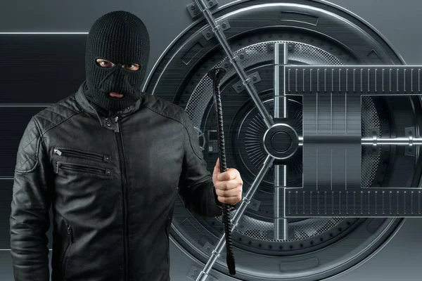 Masked burglar with crowbar in the background. Bank vault doors, large safe, bank robbery. The concept of deposit protection, protection of savings. Copy space, mixed medi