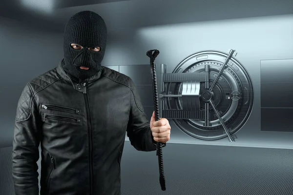 Masked burglar with crowbar in the background. Bank vault doors, large safe, bank robbery. The concept of deposit protection, protection of savings. Copy space, mixed medi