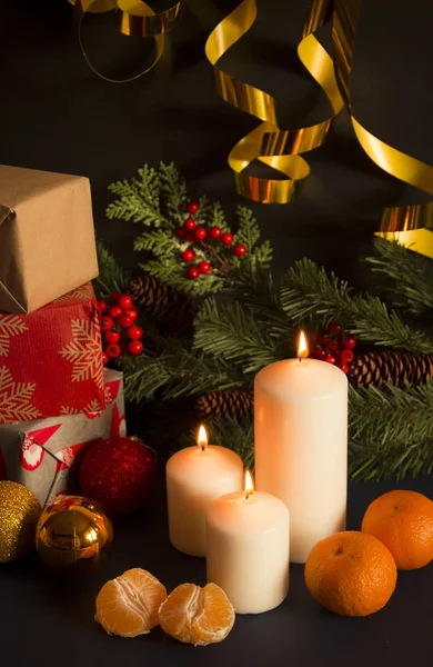 Christmas still life with candles, gifts and ornaments