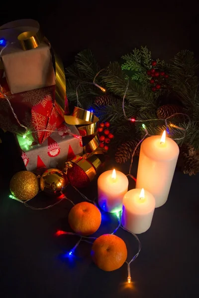 Christmas still life with candles, gifts and ornaments