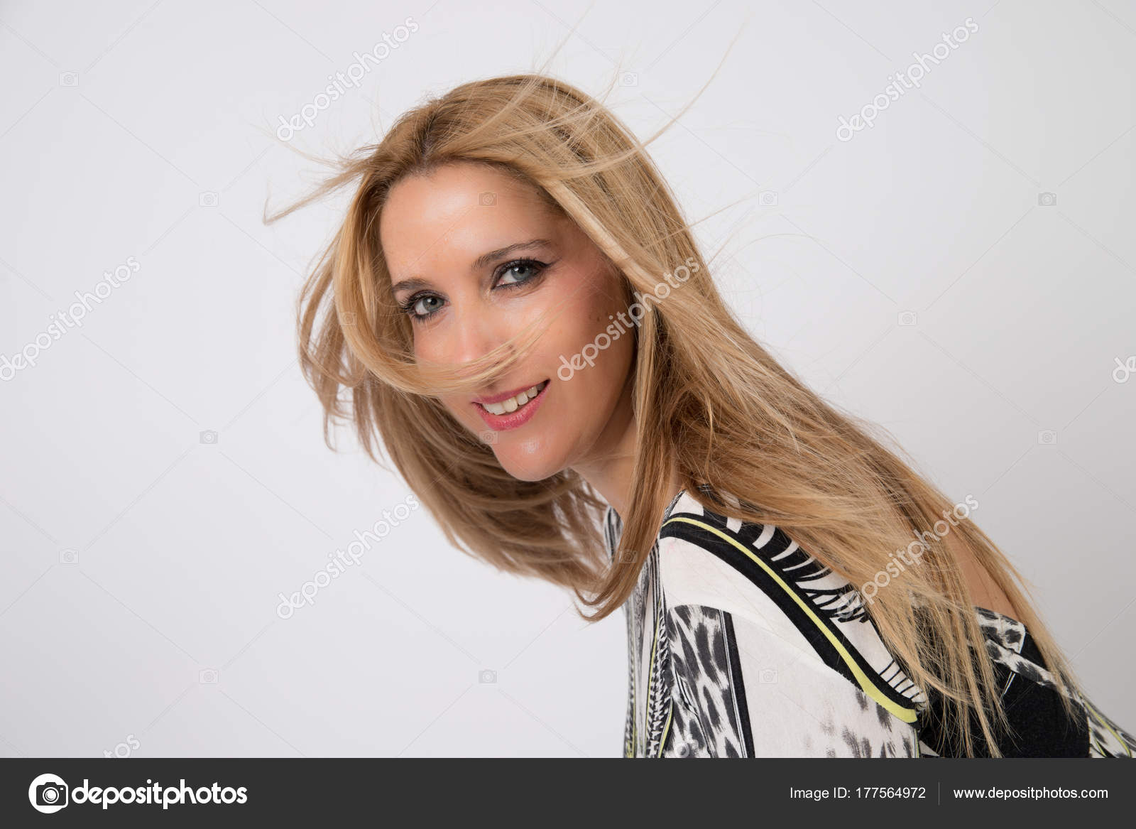 Woman With Blonde Hair And Blue Eyes In Photographic Studio