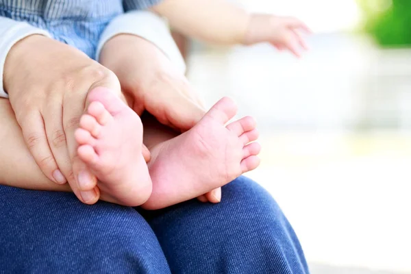little feet in the mother's hands