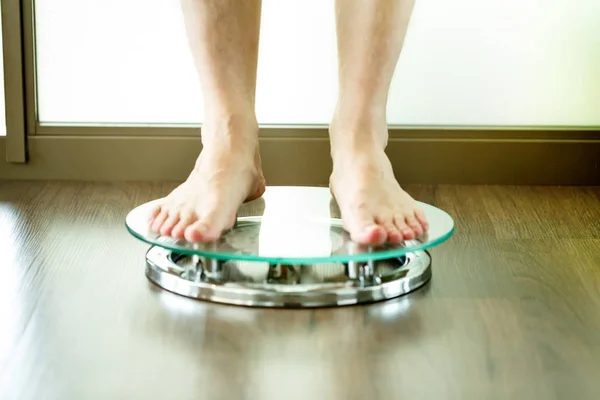 Male on standing on glass floor weight scales, close up — Stock Photo, Image