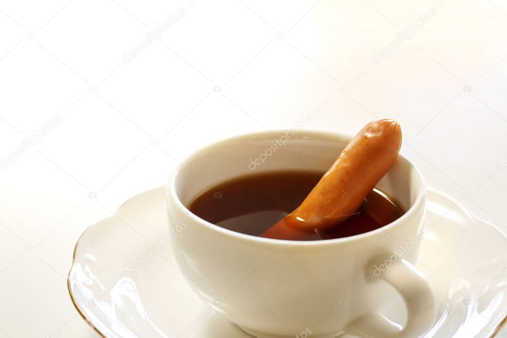A cup of tasty coffee with a sausage, isolated on white. It's called Vienna coffee in japanese.