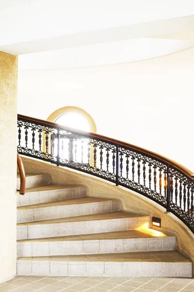 Marble spiral staircase with a black and brown fence. — Stock Photo, Image