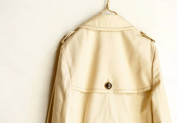 The back of a beige elegant trench coat isolated over white — Stock Photo, Image