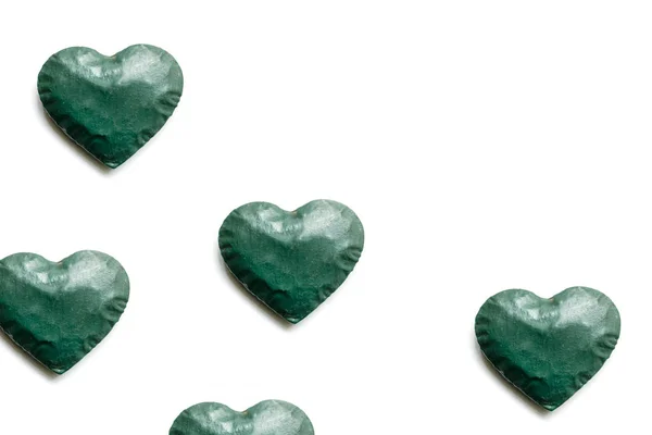 green hearts and white background and copy space.