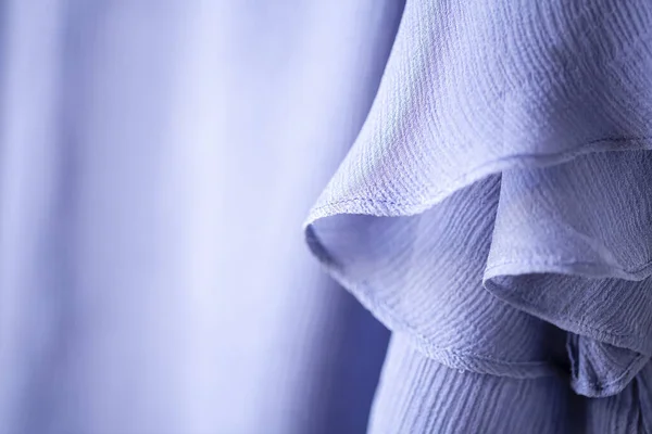 A curtain or clothes of the purple blue and sunshine.Close up