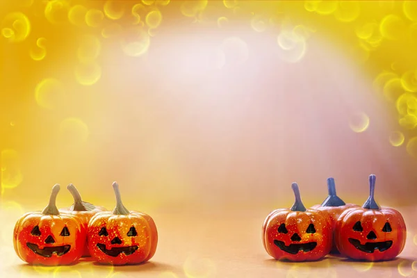 small smile pumpkins on bright with orange background and copy space and colorful with sparkly.