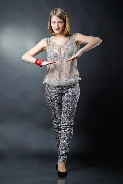 Girl in studio on dark background — Stock Photo, Image