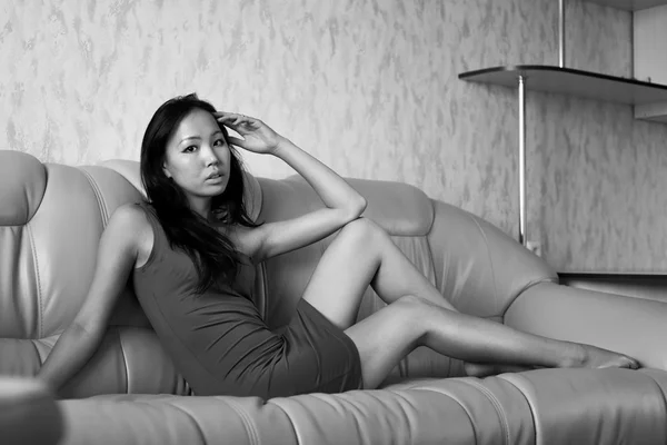 Sad asian woman on sofa — Stock Photo, Image