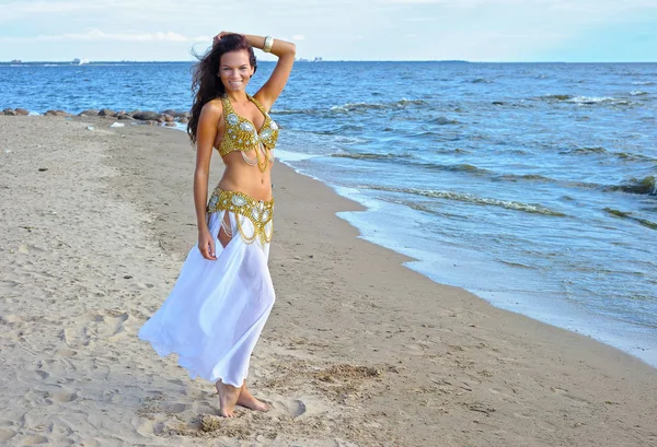 Beautiful woman in white exotic dress near sea — Stock Photo, Image