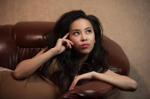 Young woman on the couch — Stock Photo, Image