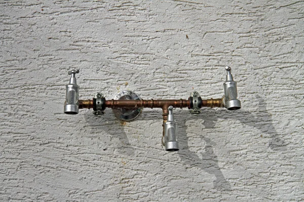 three garden water taps