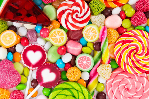 Colorful lollipops and different colored round candy.  