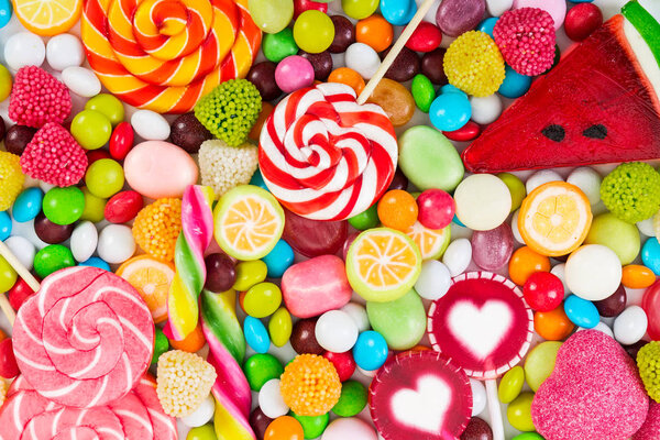 Colorful lollipops and different colored round candy.  