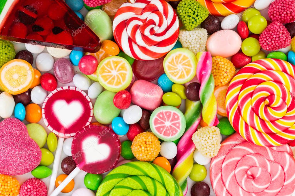 Colorful lollipops and different colored round candy. Top view.