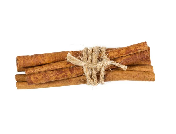 Cinnamon sticks tied with string, isolated on white — Stock Photo, Image