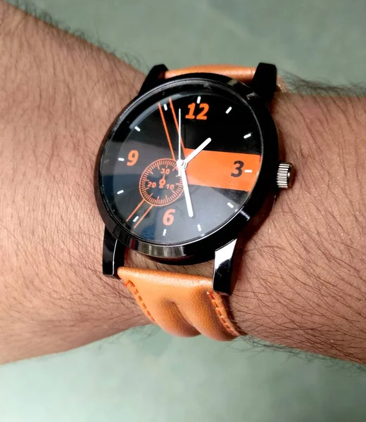 Hand with old and rusty wrist watch showing time on white background