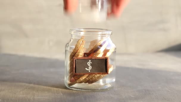 Saving money jar. Golden coins and tag. — Stock Video