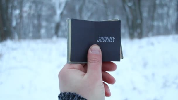 Journey word. Traveler holds a book in his hand with the inscription — Stock Video