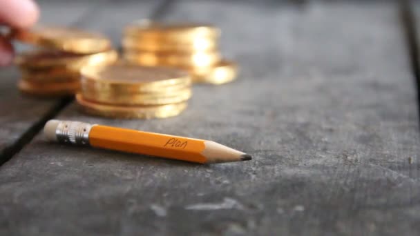 Business idea concept. Pencil with text and golden coins on vintage table. Copy space. — Stock Video
