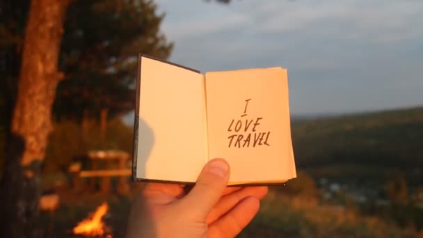 I love Travel concept. Book with with motivational inscription. Forest in the background. — Stock Video