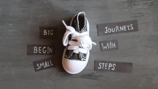 Big journeys begin with small steps, label and vintage sneakers — Stock Video