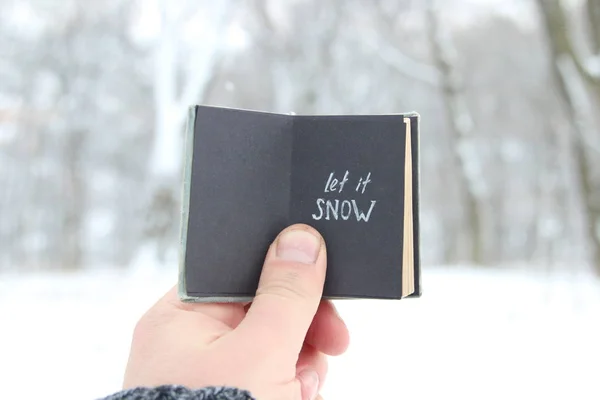 Let it snow lettering. Vintage book with inscription — Stock Photo, Image