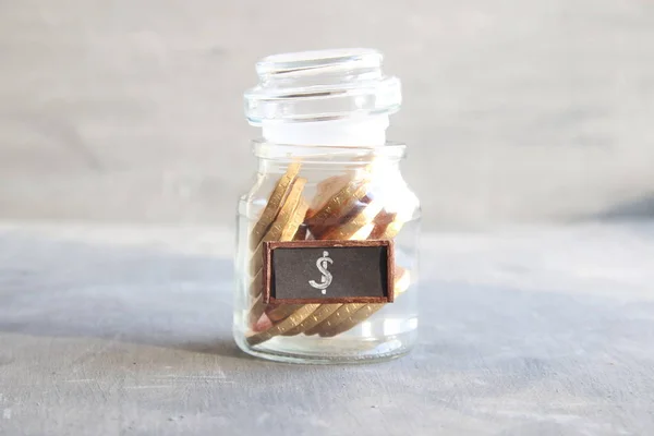 Saving money jar. Golden coins.