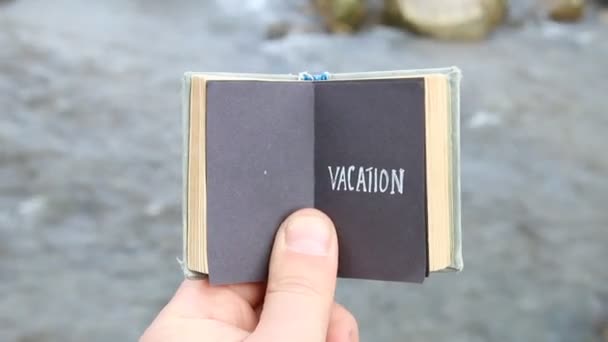 Concepto de vacaciones, viajero tiene un libro con texto — Vídeo de stock