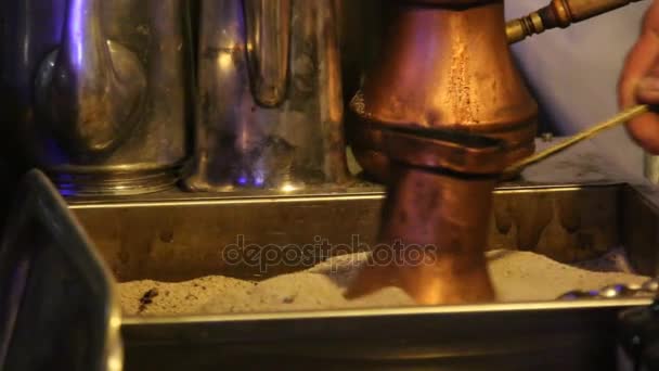 Traditional turkish coffee being prepared in hot sand — Stock Video