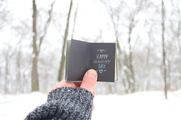 Glad Alla hjärtans dag, man håller en bok med inskriptionen — Stockfoto