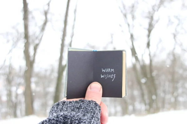 Warm wishes, man holding a book with the inscription — Stock Photo, Image