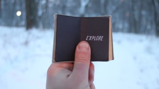 Explore, man holds a book in his hand with the inscription — Stock Video