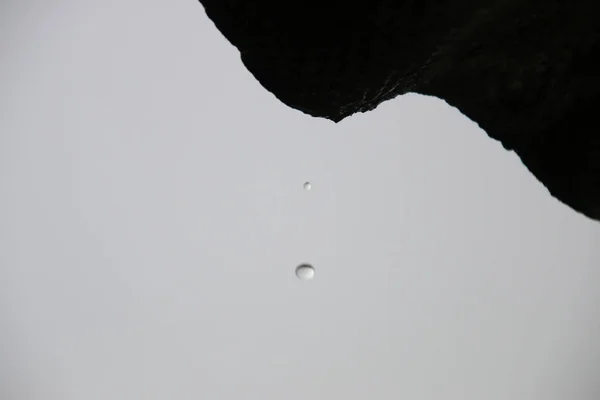 Rain idea, drop falls from the roof. Blurred photo for background — Stock Photo, Image