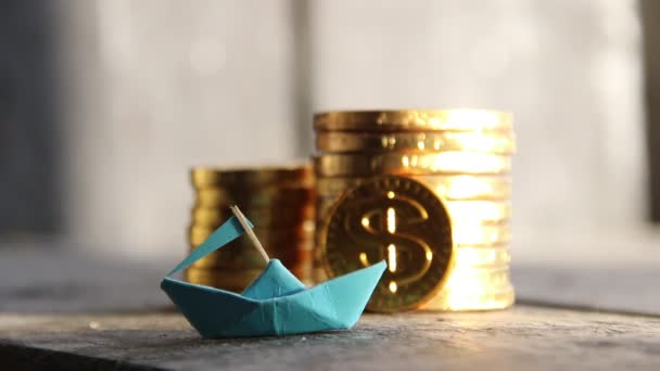 Successful startup concept, graph of gold coins and a paper boat — Stockvideo