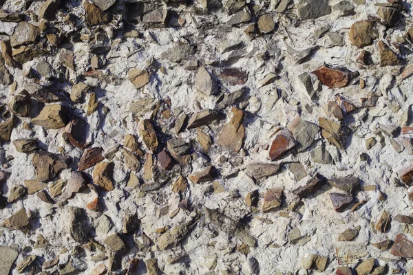 concrete wall mixed with small natural stones, background texture