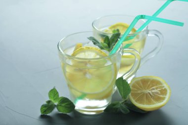 Gri arka planda iki bardak limonata, tonlu mavi renk, metin için yer