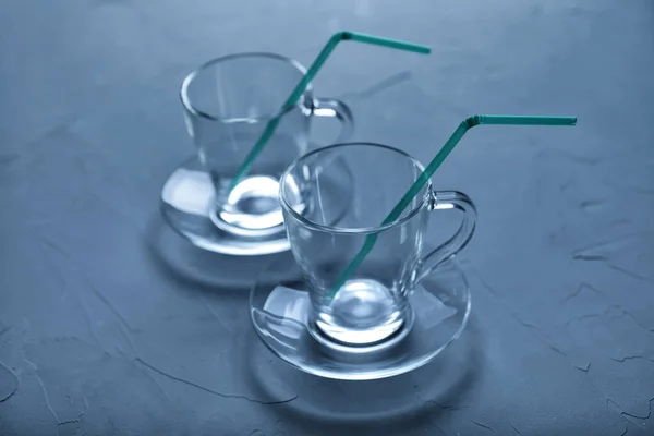 Two Empty Glass Cups Stand Concrete Background Toned Blue Color — Stock Photo, Image