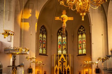 Lulea, İsveç - 05 Temmuz 2019: Güneş ışığında Katolik Katedrali, gün batımında İsa 'nın heykeli