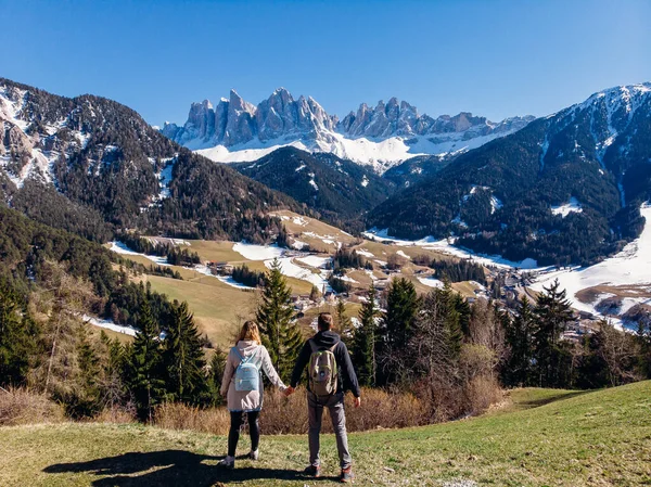 Couple love tourists Alps mountain Santa Maddalena village with Dolomites in background Val di Funes valley, Italy