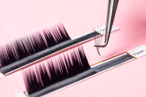 Eyelash extension procedure. Lashes set macro photo, pink background — Stock Photo, Image