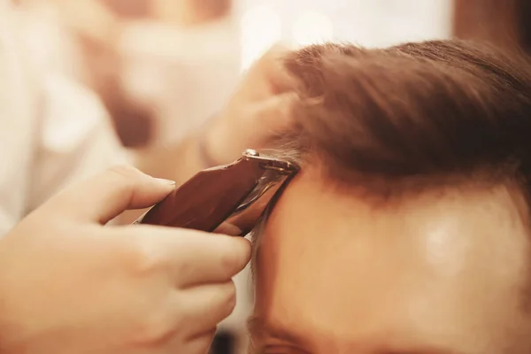 Kapperszaak, Man in stoel, kapper styling van zijn haar — Stockfoto